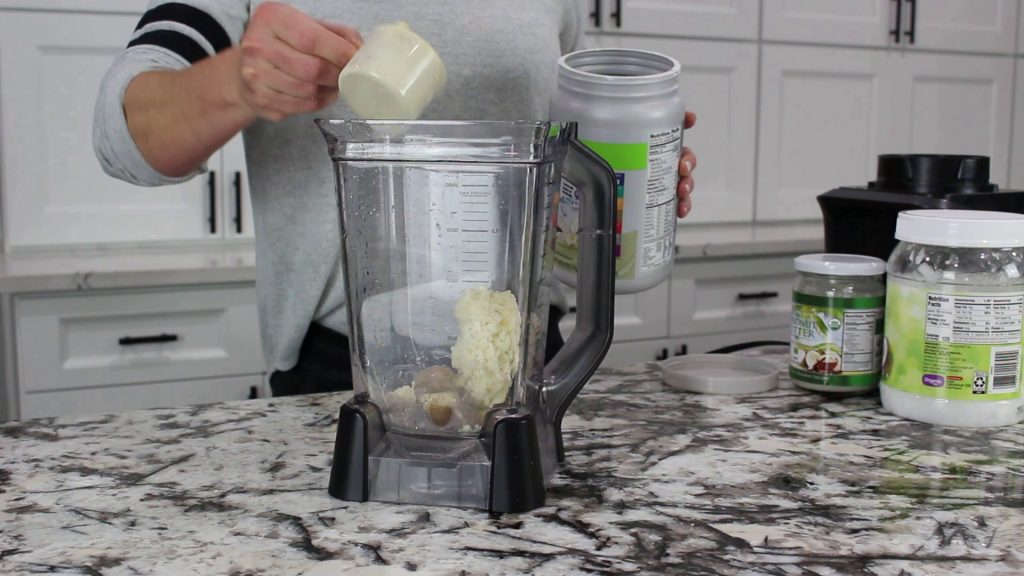 putting protein powder into a blender