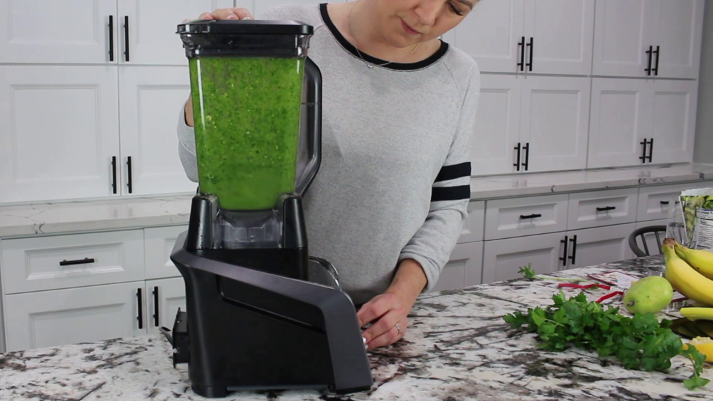 blending a citrus pear smoothie in a high powered blender