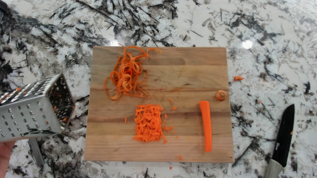 shredded and grated carrots on a cutting board