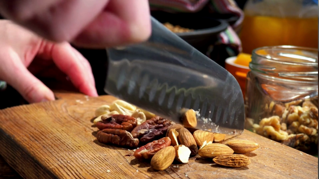 chopping assorted nuts on a cutting board