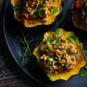 a black plate topped with three stuffed acorns